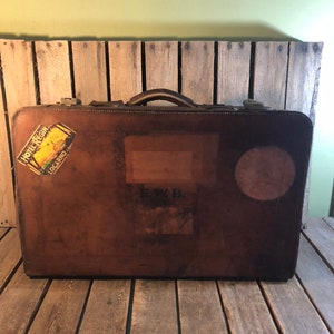 Old vintage suitcase with travel labels Stock Photo by ©PHOTOLOGY1971  53434113