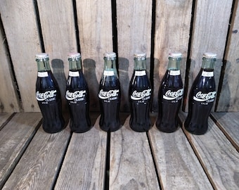 6 Coca Cola Bottles