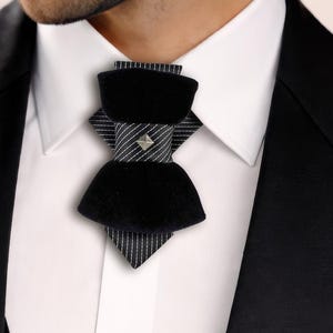 black velvet vertical bow tie, designer statement tie for men, unique groom wedding bow tie, handmade velvet bow tie, modern vertical bow tie design, black velvet groom tie, artistic men’s neckwear accessory, luxury designer bow tie, pinstripe accent bow tie, metallic stud bow tie detail, elegant groom wedding accessory, contemporary formal bow tie, unique men’s wedding tie, statement bow tie for tuxedo, modern groom style tie, fashion forward men’s bow tie, handcrafted designer necktie