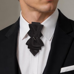 unique tie for groom, black bow tie for wedding, minimalist bow tie, stylish tie, wedding black tie, statement neckwear, modern necktie, formal neckwear, luxury fashion accessory, handcrafted men’s wear, chic fashion tie, groomsmen gift idea, vertical bow tie, timeless style tie, elegant neckwear, artisan accessories, tailored necktie, unisex tie, classic necktie, handmade necktie