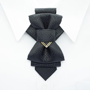 black vertical bow tie, handmade bow tie, pre tied bow tie, cascading bow tie, groom bow tie, wedding bow tie, unique bow tie, sculptural bow tie, black necktie, designer bow tie, bow tie for men, formal bow tie, gold accent bow tie, statement bow tie, luxury bow tie, handmade in Lithuania, bow tie for wedding, elegant bow tie, modern bow tie, bow tie with gold detail, viscose bow tie, bow tie gift for groom, black tie alternative, bow tie for musicians, unisex bow tie