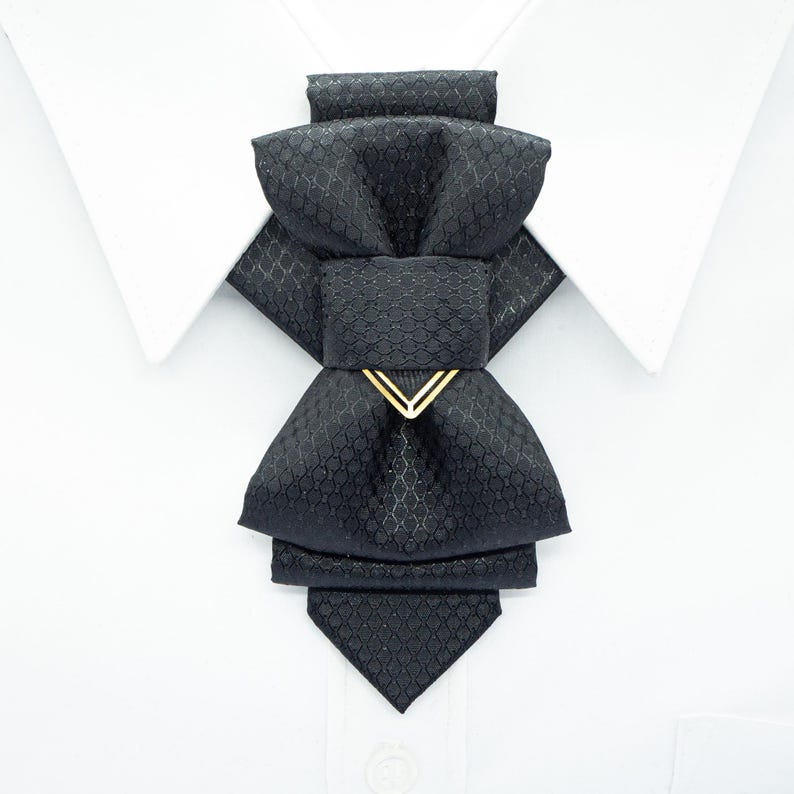 black vertical bow tie, handmade bow tie, pre tied bow tie, cascading bow tie, groom bow tie, wedding bow tie, unique bow tie, sculptural bow tie, black necktie, designer bow tie, bow tie for men, formal bow tie, gold accent bow tie, statement bow tie, luxury bow tie, handmade in Lithuania, bow tie for wedding, elegant bow tie, modern bow tie, bow tie with gold detail, viscose bow tie, bow tie gift for groom, black tie alternative, bow tie for musicians, unisex bow tie