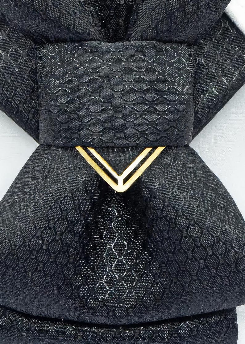 black vertical bow tie, handmade bow tie, pre tied bow tie, cascading bow tie, groom bow tie, wedding bow tie, unique bow tie, sculptural bow tie, black necktie, designer bow tie, bow tie for men, formal bow tie, gold accent bow tie, statement bow tie, luxury bow tie, handmade in Lithuania, bow tie for wedding, elegant bow tie, modern bow tie, bow tie with gold detail, viscose bow tie, bow tie gift for groom, black tie alternative, bow tie for musicians, unisex bow tie