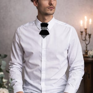 modern vertical bow tie design, black velvet groom tie, artistic men’s neckwear accessory, luxury designer bow tie, pinstripe accent bow tie, metallic stud bow tie detail, elegant groom wedding accessory, contemporary formal bow tie, unique men’s wedding tie, statement bow tie for tuxedo, modern groom style tie, fashion forward men’s bow tie, handcrafted designer necktie, artistic groom accessory, elegant velvet neckwear, distinctive vertical bow tie