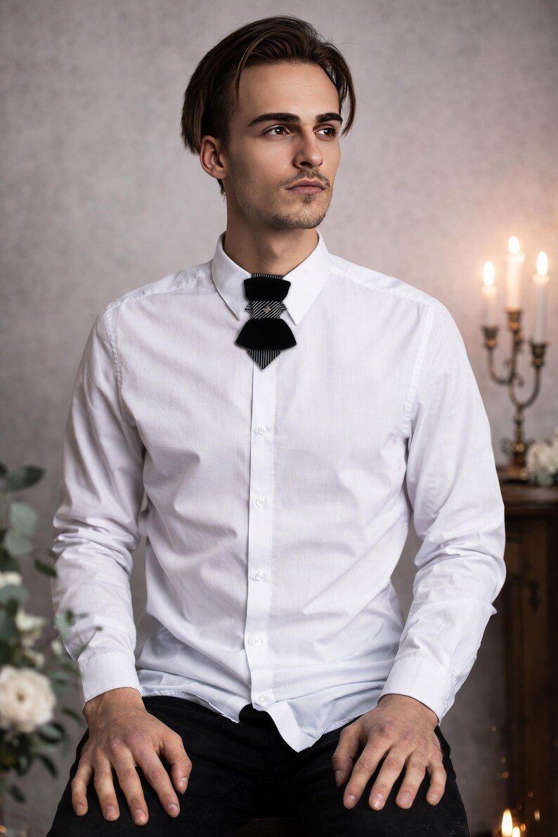 modern vertical bow tie design, black velvet groom tie, artistic men’s neckwear accessory, luxury designer bow tie, pinstripe accent bow tie, metallic stud bow tie detail, elegant groom wedding accessory, contemporary formal bow tie, unique men’s wedding tie, statement bow tie for tuxedo, modern groom style tie, fashion forward men’s bow tie, handcrafted designer necktie, artistic groom accessory, elegant velvet neckwear, distinctive vertical bow tie
