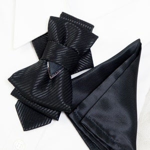 unique tie for groom, black bow tie for wedding, minimalist bow tie, stylish tie, wedding black tie, statement neckwear, modern necktie, formal neckwear, luxury fashion accessory, handcrafted men’s wear, chic fashion tie, groomsmen gift idea, vertical bow tie, timeless style tie, elegant neckwear, artisan accessories, tailored necktie, unisex tie, classic necktie, handmade necktie