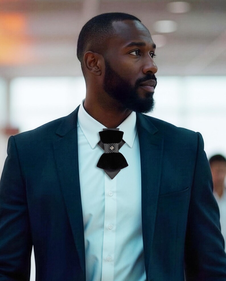 black velvet vertical bow tie, designer statement tie for men, modern vertical bow tie design, black velvet groom tie, luxury designer bow tie, pinstripe accent bow tie, metallic stud bow tie detail, elegant groom wedding accessory, contemporary formal bow tie, unique men’s wedding tie, statement bow tie for tuxedo, modern groom style tie, fashion forward men’s bow tie, handcrafted designer necktie, artistic groom accessory, elegant velvet neckwear, distinctive vertical bow tie