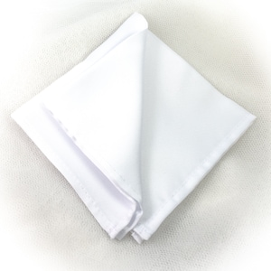 May include: A folded white pocket square, made of a smooth fabric, is displayed against a white background. The square is neatly folded, showcasing its clean lines and crisp edges. The pocket square is a classic accessory.