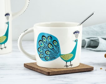 Handmade Ceramic Peacock Mug, designed in the UK by Hannah Turner. Perfect Mug for Morning Tea or Coffee, Gift Boxed Pottery Mug