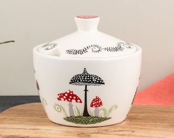 Toadstool Sugar Bowl, handmade ceramic toadstool design lidded pot, designed in UK by Hannah Turner, with vintage toadstool amongst plants