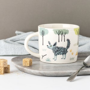 Handmade Ceramic Dog Mug 1, designed in the UK by Hannah Turner, gift boxed Dog Gift for dog lovers. Terrier and Labrador dogs with trees