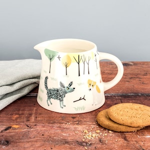 Handmade Ceramic Dog Milk Jug, designed in the UK by Hannah Turner, gift boxed Dog Gift for dog lovers. Terrier and Labrador dogs with trees