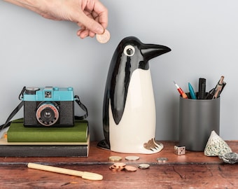 Handmade Ceramic Penguin Money Box, designed in the UK by Hannah Turner. Get saving in style with this retro Penguin Money Bank.