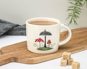 Handmade ceramic Toadstool Mug, designed in the UK by Hannah Turner. Retro mushrooms and toadstools adorn this perfectly sized mug.