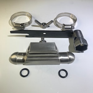 May include: A silver metal plumbing valve with two round ends, a black metal wrench, two silver metal hose clamps, and two black rubber O-rings.