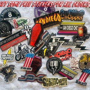 May include: A collection of colorful stickers featuring motorcycle designs and the text "San Diego Chopper". The stickers have a variety of designs, including a motorcycle with flames, a skull, and a lightning bolt. The stickers are perfect for adding a touch of personality to your motorcycle, laptop, or water bottle.