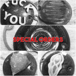 May include: A collection of round, black, glitter-covered metal covers with various designs. The covers have a textured surface and are perfect for adding a unique touch to any project. The covers are available in a variety of designs, including a simple circle, a swirl pattern, and a design with the words "SPECIAL ORDERS".