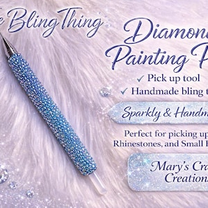 May include: A handmade diamond painting pen, covered in blue and silver crystals. The pen is a pick-up tool for gems and beads. The image text reads "The Bling Thing" and "Diamond Painting Pen".