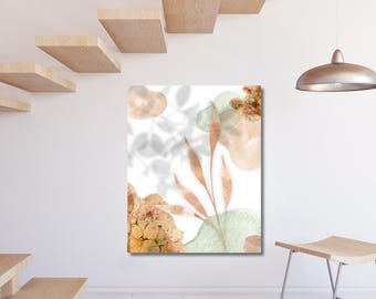 May include: Abstract art print featuring watercolor shapes in peach, green, and gold tones, with leaf and floral accents. The artwork is displayed on a white wall, complemented by wooden stairs and a modern light fixture.