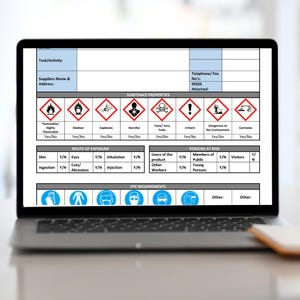 May include: A laptop screen displaying a safety data sheet with hazard symbols. The sheet includes sections on substance properties, route of exposure, persons at risk, and PPE requirements. The laptop is open on a desk.