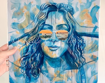 May include: A painting of a woman with long blue hair wearing sunglasses. The reflection in the sunglasses shows a beach scene with a pier and a sunset. The painting is done in a watercolor style with splashes of blue, yellow, and orange.