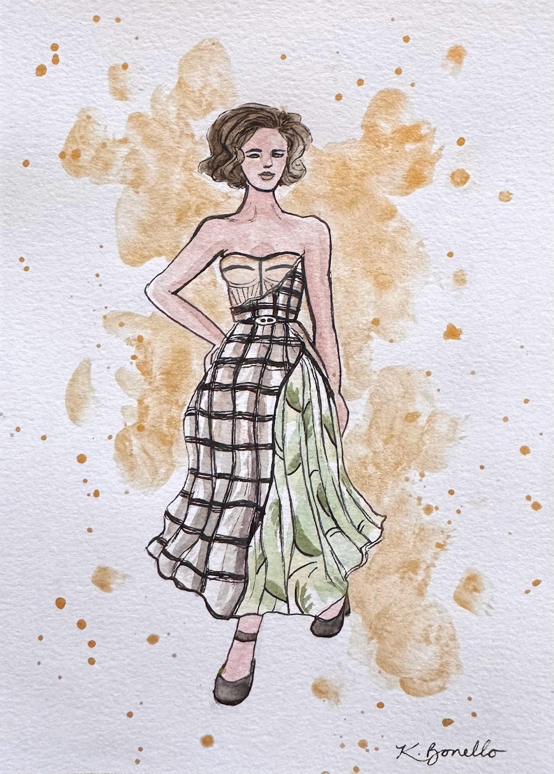 Peut inclure: Une tasse en c&eacute;ramique blanche avec une anse noire et le texte "But First, Coffee" en noir, en gras. La tasse est pos&eacute;e sur une surface blanche.