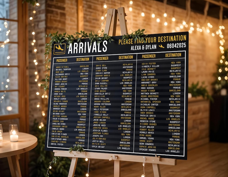 May include: A black chalkboard sign with white text lists the names of wedding guests and their assigned destinations. The sign is titled "Arrivals" and includes the names "Alexa & Dylan" and the date "06042025".