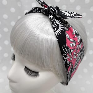 Puede incluir: Una taza de cerámica blanca con un asa negra y el texto "But First, Coffee" en negrita negra. La taza se encuentra sobre un fondo borroso, sugiriendo un ambiente acogedor.