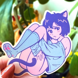 May include: A sticker of a cartoon cat girl with blue socks and a light blue shirt. She has black hair and a pink face with a sad expression. The sticker is on a white background.