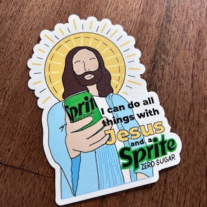May include: A sticker featuring an illustration of Jesus holding a green Sprite Zero Sugar can. Jesus is depicted with long brown hair, a beard, and a halo. The text reads, "I can do all things with Jesus and a Sprite."