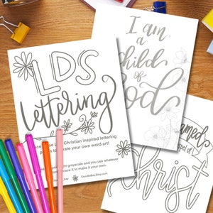 May include: Three printable coloring pages featuring Christian-inspired lettering. The first page says "LDS Lettering" with a floral design. The second page says "I am a child of God" with a floral design. The third page says "Baptized into the Gospel of Christ" with a cross and floral design.