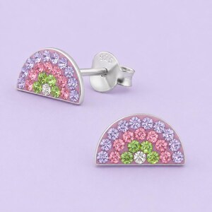 May include: A pair of sterling silver stud earrings in a semi-circle rainbow shape. Each earring features rows of small, faceted crystals in shades of light purple, pink, and lime green, with a single clear crystal at the center base.