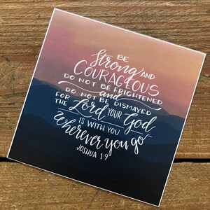 May include: A motivational quote with a sunset mountain background. The quote reads "Be strong and courageous. Do not be frightened and do not be dismayed, for the Lord your God is with you wherever you go." The quote is attributed to Joshua 1:9.