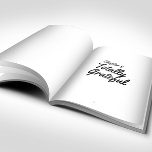 May include: An open book with white pages, displaying the text "Chapter 5 Totally Grateful" in black script. The book is slightly angled, with several pages visible, set against a white background.