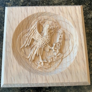 May include: A wooden plaque with a carved design of a bird with outstretched wings, holding a scroll in its beak. The scroll reads "For God and Country".