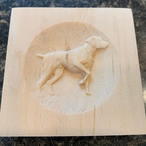 May include: A wooden plaque with a carved image of a dog in a circular frame.