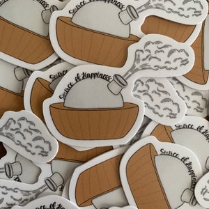 May include: A set of three ceramic mugs with a speckled, matte finish. The mugs are in shades of cream, light gray, and dark gray. Each mug has a simple, minimalist design and a rounded handle.