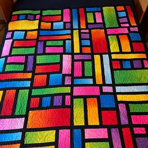 Bright gradient colored throw size quilt