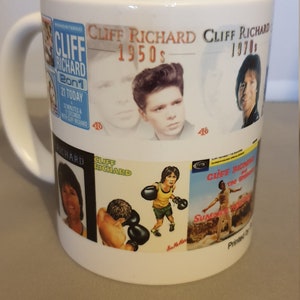 May include: White ceramic mug with a collage of Cliff Richard album covers from the 1950s and 1970s. The mug features images of Cliff Richard, album titles, and release dates.