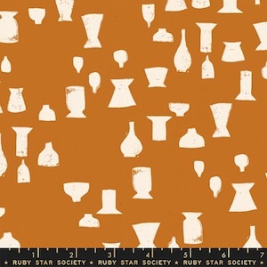 May include: A fabric with a repeating pattern of white vase and bowl shapes on a burnt orange background. The design includes various sizes and styles of vessels, creating a textured, artistic look. The text "RUBY STAR SOCIETY" is at the bottom.