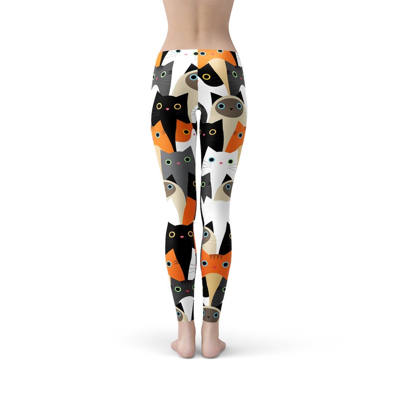 May include: Black, white, orange, and gray cat leggings with a repeating pattern of cat faces.