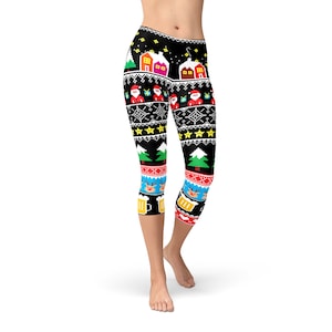 May include: Black leggings with a colourful Christmas-themed pattern. The pattern includes houses, Santa Claus, reindeer, and beer mugs.