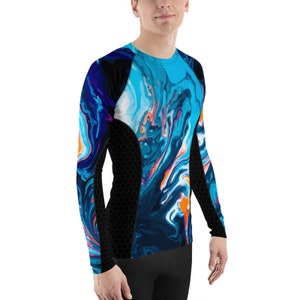 May include: A long-sleeved compression shirt with a blue, white, and orange abstract pattern. The shirt has a black mesh panel on the side.