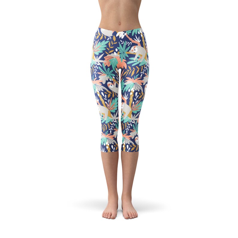 May include: Blue capri leggings with a colorful pattern of sloths and tropical plants.