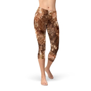 May include: Brown and gold patterned cropped leggings with a geometric design.