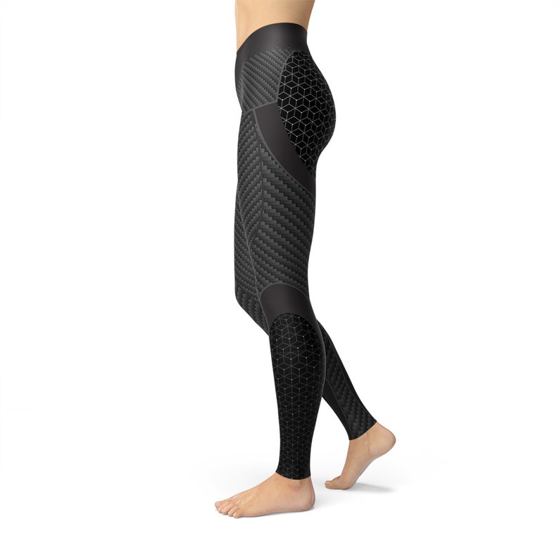May include: Black leggings with a geometric pattern. The leggings have a high waist and a tight fit.