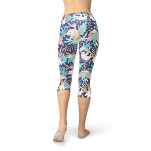 May include: Blue capri leggings with a colorful print of sloths and tropical leaves.