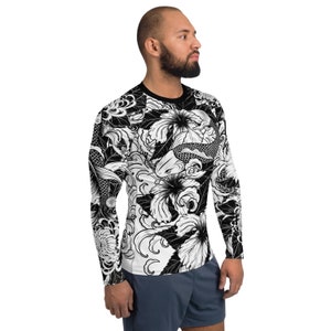May include: Black and white long-sleeved shirt with a graphic print of koi fish, flowers, and waves.