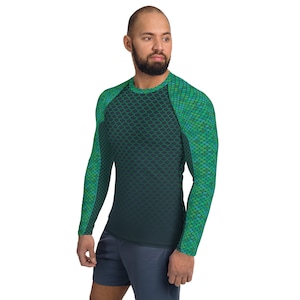 May include: A long-sleeved shirt with a green and blue scale pattern. The shirt has a dark green to black gradient.