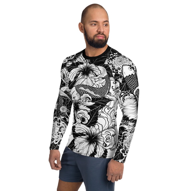 May include: Black and white long-sleeve shirt with a graphic print of koi fish, flowers, and waves.